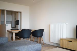 a living room with a table and chairs at Appartement Caraibes 6de verdieping in Blankenberge