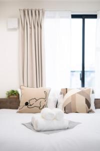 a bedroom with a bed with two towels on it at The Peak Tsutenkaku in Osaka