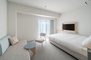 Postel nebo postele na pokoji v ubytování ITOMACHI Hotel 0