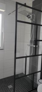 a shower with a glass door in a bathroom at E+E Apartment Nah am Centro in Oberhausen +14 photos