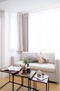 a living room with a couch and two tables at The Peak Tsutenkaku in Osaka +35 photos