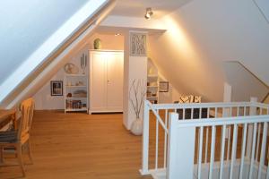 a staircase in a house with a white stair case at Modernes Appartement mit Meerblick in Ahrenshoop