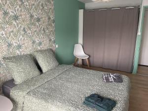 a bedroom with a bed with a pair of shoes on it at Croix rouge in Châtellerault
