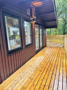 a screened in porch of a house with windows at Snowdrop 14 Hot tub-Woodlandlodges-Tenby-Pendine in Carmarthen
