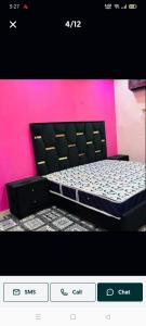 a picture of a bed in a room at New Faizan Hotel in Lahore