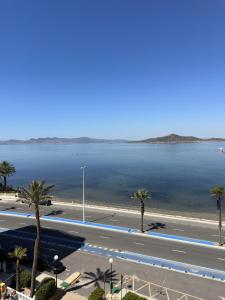 a view of a large body of water with palm trees at Hawaii V 25B - La Manga By WATERMELON in La Manga del Mar Menor