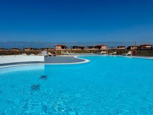 MajanichoにあるVilla Kandoomaの青い水と椅子のある大きなプール