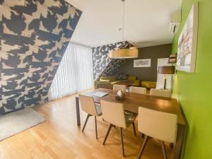 a dining room with a wooden table and chairs at Abieshomes Serviced Apartments - Votivpark in Vienna +12 photos