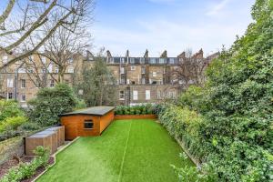 a garden in front of a building at Cleveland Residences Chelsea in London