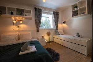 a small bedroom with a bed and a window at Bella Apartment - Sunčana dolina in Kopaonik