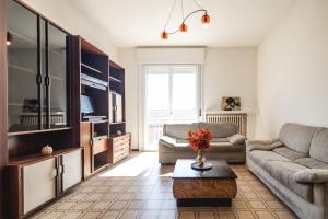 una sala de estar con un sofá y una mesa en Art Haven Apartment Ravenna, en Rávena