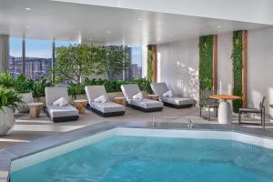 a swimming pool in a building with chairs and a table at The Ritz-Carlton, Portland in Portland