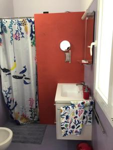 a bathroom with a shower curtain and a sink at La Casa di Anna in Palmi +30 photos