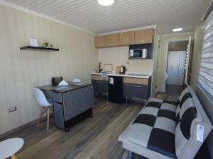 a small kitchen with a couch and a desk in a room at Hotel Cecil in Vallenar