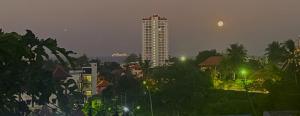 a view of a city at night with a tall building at BOUTIQUE-VILLA with Suites & Rooms in Karon Beach
