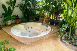 a bath tub in a garden with potted plants at BOUTIQUE-VILLA with Suites & Rooms in Karon Beach +67 photos