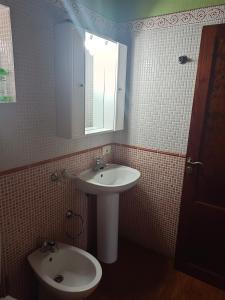 a bathroom with a sink and a toilet and a mirror at Casa Rural de Abuelo in Garafía +11 photos