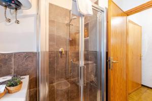 a shower with a glass door in a bathroom at La Casa del Pittore 2 in Bardonecchia +17 photos