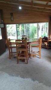 a dining room with a table and chairs and windows at Barton Creek Unique Resort in Sayab Camp