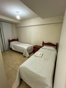 a room with two beds in a room at Cielo Norteño in San Salvador de Jujuy