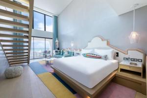 a bedroom with a white bed and a staircase at W Algarve in Albufeira