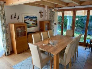 a dining room with a wooden table and chairs at Haus Kleeblatt im Chiemgau in Siegsdorf