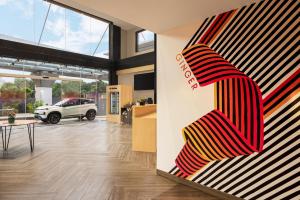 a store lobby with a red and yellow striped wall at Ginger Coimbatore Airport , Avinashi Road in Coimbatore