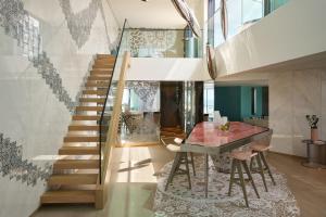 a staircase in a house with a table and a dining room at W Algarve in Albufeira