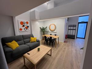 a living room with a couch and a table at LOFT Accommodative A in Valencia