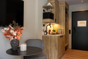 a living room with a table and a kitchen at Stryn House Hotel - New Management in Stryn