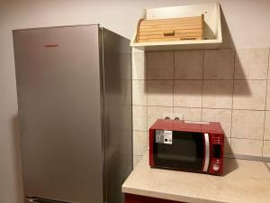 a microwave sitting on a counter next to a refrigerator at Apartman Nono in Dubrovnik