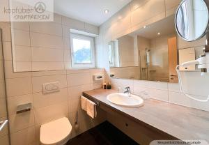Koupelna v ubytování Sporthotel Bergheim + 37 fotografií
