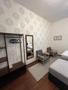 a bedroom with a bed and a mirror at Sahara Hosting Apartments Nürnberg City Room 1 in Nuremberg +26 photos