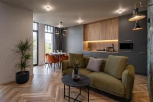 a living room with a couch and a table at Ridge Apartments in Chernivtsi