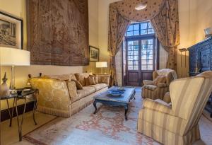 a living room with a couch and two chairs and a table at The Xara Palace Relais & Chateaux in Mdina