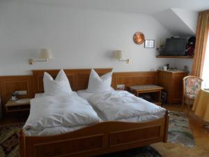 a bedroom with two beds with white pillows at Pension Lichterturm in Beuren