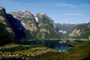 a view of a mountain range with a town and a lake at Seeblick Krippenstein in Obertraun