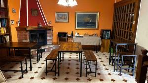 a living room with tables and chairs and a fireplace at Dimora Ippocastano in Colli al Volturno