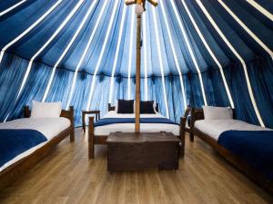 a room with two beds in a yurt at Warwick Castle Hotel & Knight's Village in Warwick