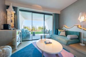 a living room with a couch and a table at W Algarve in Albufeira