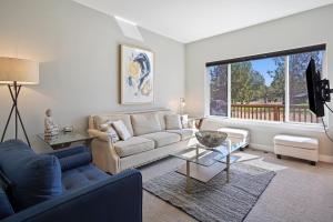 a living room with a couch and a table at Present Pheasant home in Redmond