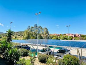 a parking lot with solar panels on the roof at Hotel San Teodoro in San Teodoro