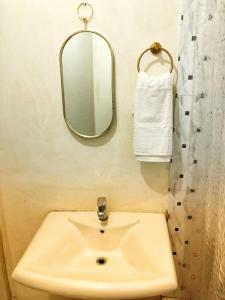 a bathroom with a sink and a mirror at Chill Spot in Old Harbour in Old Harbour