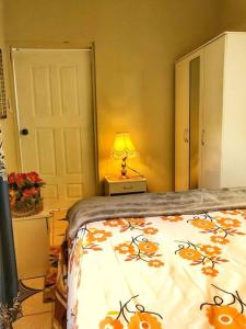 a bedroom with a bed and a lamp on a table at Chill Spot in Old Harbour in Old Harbour