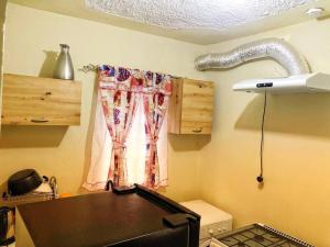 a kitchen with a window and a table in a room at Chill Spot in Old Harbour in Old Harbour