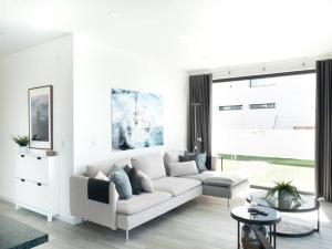 a white living room with a couch and a table at Praceta Porthaus - entire private main home in Santo Isidoro