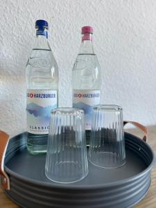 a tray with two bottles and two glasses on it at Aura - Nula #2 - 2 Zimmer, 4 Betten, Küche, Balkon, Waschmaschine in Merseburg