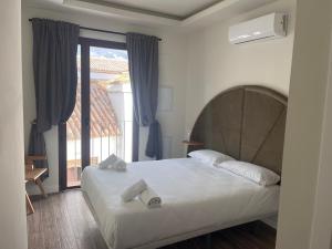 een slaapkamer met een bed en een groot raam bij Corazón 23 in Córdoba +134 foto's