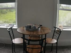 a table and chairs with a bowl on top of it at Fort View accommodation lisacul in Lisacul
