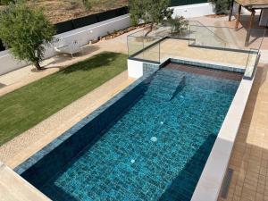 eine Draufsicht auf einen Swimmingpool in einem Haus in der Unterkunft Monte Gerações - Complete House - Heated pool - Typical Algarvian - close to Quinta Lago Vale Lobo and Vilamoura in Almancil